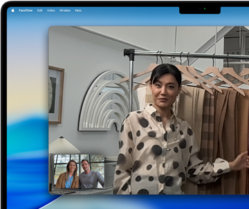 A video call on a MacBook Pro where a woman shows fabrics to two people on the call, with Center Stage keeping her centered in the frame as she moves around